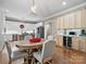 Elegant dining area with hardwood floors, chandelier, and stylish furnishings, complemented by a built-in wine fridge at 1725 Hannon Farm Rd, Fort Mill, SC 29715