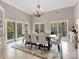 Elegant dining room with large windows, chandelier lighting, and seating for eight at 1725 Hannon Farm Rd, Fort Mill, SC 29715