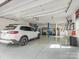 Spacious garage interior with a car lift, epoxy flooring, and a white SUV parked inside at 1725 Hannon Farm Rd, Fort Mill, SC 29715