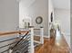 Spacious hallway with hardwood floors, statement mirror and vaulted ceilings provides an elegant transition between rooms at 1725 Hannon Farm Rd, Fort Mill, SC 29715