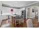 Bright and airy kitchen featuring stainless steel appliances, a center island, and white cabinetry with hardwood floors at 1725 Hannon Farm Rd, Fort Mill, SC 29715