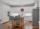 Well-designed kitchen with an island, stainless steel appliances, white cabinets, and hardwood floors for a modern touch at 1725 Hannon Farm Rd, Fort Mill, SC 29715