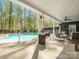 Backyard pool with slide, patio, lounge chairs, and a covered porch at 1725 Hannon Farm Rd, Fort Mill, SC 29715