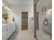 Bright bathroom featuring double vanity, large mirror, and glass shower door at 2014 Puddle Pond Rd, Indian Trail, NC 28079