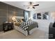 Comfortable bedroom with dark wood accents, checkered bedding, and ambient lighting at 2014 Puddle Pond Rd, Indian Trail, NC 28079