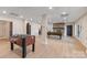 Finished basement featuring a foosball table, pool table, stone fireplace, and light wood flooring at 239 Paradise Peninsula Rd, Mooresville, NC 28117