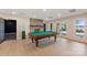 Basement game room featuring a pool table, stone fireplace, and access to an outdoor patio at 239 Paradise Peninsula Rd, Mooresville, NC 28117