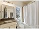 Cozy bathroom featuring tub and shower, with a vanity and natural light at 239 Paradise Peninsula Rd, Mooresville, NC 28117