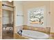Elegant bathroom featuring a shower, soaking tub, and a large window with scenic views at 239 Paradise Peninsula Rd, Mooresville, NC 28117