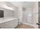 Bright bathroom with a double sink vanity, a large mirror, and a glass-enclosed shower at 239 Paradise Peninsula Rd, Mooresville, NC 28117