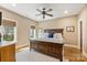 Charming bedroom featuring a wooden bed frame, ceiling fan, and two windows with wooden blinds at 239 Paradise Peninsula Rd, Mooresville, NC 28117