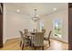 Bright dining room featuring a round table, chandelier, hardwood floors, and natural light from large windows at 239 Paradise Peninsula Rd, Mooresville, NC 28117