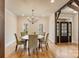 Elegant dining room with hardwood floors, modern chandelier, and access to the outdoors at 239 Paradise Peninsula Rd, Mooresville, NC 28117