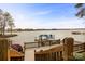 View of covered boat dock from backyard featuring wooden stairs and scenic water view at 239 Paradise Peninsula Rd, Mooresville, NC 28117