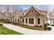 Side view of a well-maintained house featuring stone accents, manicured landscaping, and a curved driveway at 239 Paradise Peninsula Rd, Mooresville, NC 28117