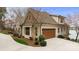 The side of a two-story house with a brown garage door, stone accents, and a curved driveway at 239 Paradise Peninsula Rd, Mooresville, NC 28117