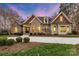Charming stone and siding home with a well-manicured lawn and a long, curved driveway at 239 Paradise Peninsula Rd, Mooresville, NC 28117