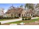 Charming stone and siding home with a well-manicured lawn and a long, curved driveway at 239 Paradise Peninsula Rd, Mooresville, NC 28117