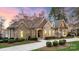 Lovely front exterior showing stone and siding, meticulous landscaping and long driveway at 239 Paradise Peninsula Rd, Mooresville, NC 28117
