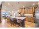 Island kitchen with a white countertop, wooden cabinets, stainless steel appliances, pendant lights, and a dining nook at 239 Paradise Peninsula Rd, Mooresville, NC 28117