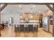 Island kitchen with a gray base, white countertop, wooden cabinets, stainless steel appliances, and pendant lights at 239 Paradise Peninsula Rd, Mooresville, NC 28117