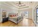 Spacious main bedroom with hardwood floors, trey ceiling, and expansive windows offering a lake view at 239 Paradise Peninsula Rd, Mooresville, NC 28117