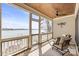 Relaxing screened porch offering serene lake views, perfect for enjoying the outdoors at 239 Paradise Peninsula Rd, Mooresville, NC 28117