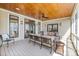 Inviting covered porch with comfortable seating and a ceiling fan for outdoor relaxation at 239 Paradise Peninsula Rd, Mooresville, NC 28117