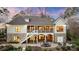 Beautiful back of home with screened porch, patio, outdoor seating, and stone accents at 239 Paradise Peninsula Rd, Mooresville, NC 28117