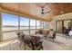 Spacious screened porch with comfortable seating, wooden ceiling, fan, and serene lake views at 239 Paradise Peninsula Rd, Mooresville, NC 28117