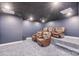 Home theater room featuring comfortable seating, a projector, and a dark color scheme at 239 Paradise Peninsula Rd, Mooresville, NC 28117