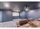 Home theater room featuring comfortable seating, a projector, and a large movie screen at 239 Paradise Peninsula Rd, Mooresville, NC 28117