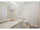 Bathroom features modern countertops, white cabinets, brushed gold hardware, and tile floors at 303 Windy Rush Rd, Kannapolis, NC 28081