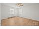 Cozy bedroom featuring a ceiling fan, two windows, and wood flooring at 303 Windy Rush Rd, Kannapolis, NC 28081