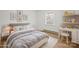 Charming bedroom with a desk area, comfortable bed, and bright natural light from the window at 303 Windy Rush Rd, Kannapolis, NC 28081