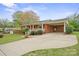 Charming single-story brick home with a covered porch, carport, and a well-manicured lawn at 303 Windy Rush Rd, Kannapolis, NC 28081