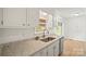 Kitchen featuring white cabinets, modern granite countertops, and stainless steel appliances at 303 Windy Rush Rd, Kannapolis, NC 28081