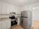 Kitchen featuring white cabinets, modern countertops, stainless steel appliances, and lots of natural light at 303 Windy Rush Rd, Kannapolis, NC 28081