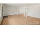 Spacious living area featuring wood floors and a view into the dining space at 303 Windy Rush Rd, Kannapolis, NC 28081