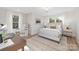Sunlit bedroom with neutral tones, a comfortable bed, and a cozy workspace at 3129 Rush Ave, Charlotte, NC 28208