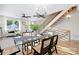 Dining room with modern table, chandelier, hardwood floors, open to living room and staircase at 3129 Rush Ave, Charlotte, NC 28208