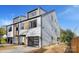 Contemporary home featuring light gray siding, a black framed garage door, and modern design elements at 3129 Rush Ave, Charlotte, NC 28208
