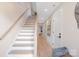Bright hallway with hardwood floors, staircase, and white doors leading to various rooms at 3129 Rush Ave, Charlotte, NC 28208