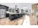 Modern kitchen with a large island, black cabinetry, stainless steel appliances, and hardwood floors at 3129 Rush Ave, Charlotte, NC 28208