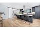 Open kitchen with a large island, black bar stools, white countertops, and a modern aesthetic at 3129 Rush Ave, Charlotte, NC 28208