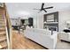 Open-concept living area with a modern fireplace, hardwood floors, and a glimpse of the kitchen at 3129 Rush Ave, Charlotte, NC 28208