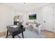 Bright office features modern decor, including a desk, chairs, and a large screen television at 3129 Rush Ave, Charlotte, NC 28208