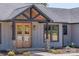 Charming home showcasing a stylish front door with a covered entrance and meticulously maintained landscaping at 32519 Buchanan Ln, Albemarle, NC 28001