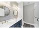 Modern bathroom with double vanity, elegant mirrors, and a glass-enclosed shower, offering a spa-like experience at 32525 Buchanan Ln, Albemarle, NC 28001