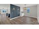 Open dining area with stylish chandelier and hardwood floors, seamlessly connected to the adjacent kitchen at 32525 Buchanan Ln, Albemarle, NC 28001